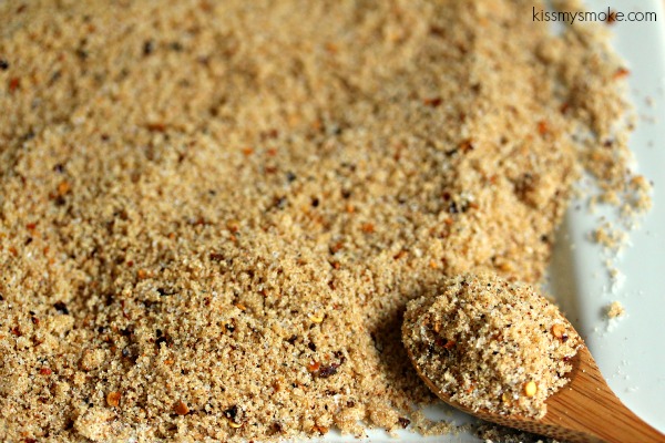 Bring Da Heat Dry Rub piled on a light counter with a spoon scooping some up.