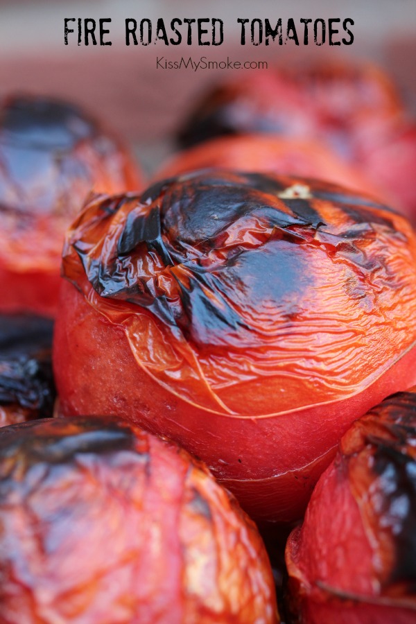 Fire roasted tomatoes with charred skin piled up in a close up image. Text at top stated the recipe name and blog name.