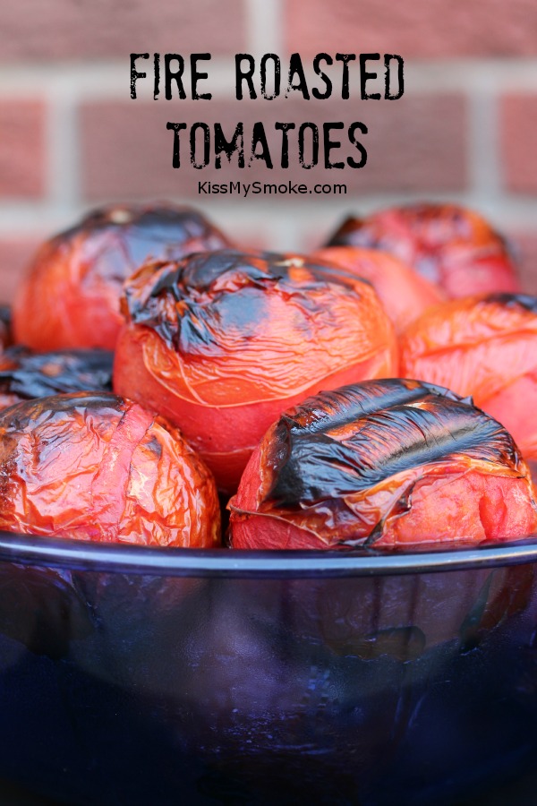 Fire roasted tomatoes in a blue bowl and a brick wall in the background.