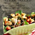 grilled steak salad in a green bowl with a red and white napkin