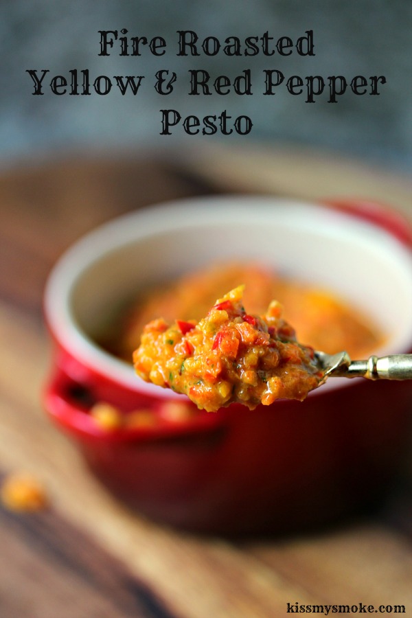 Fire Roasted Yellow and Red Pepper Pesto on a spoon with ramekin of pesto in the background
