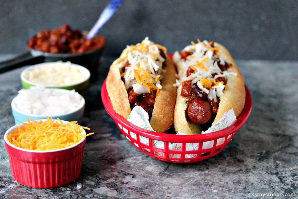 Bacon Wrapped Chili Dogs- This recipe wraps hot dogs in bacon, then tops them off with chili, onions and cheese. It's a bacon lovers dream come true. #sponsored #boldbacon @Tysontweets @Walmart