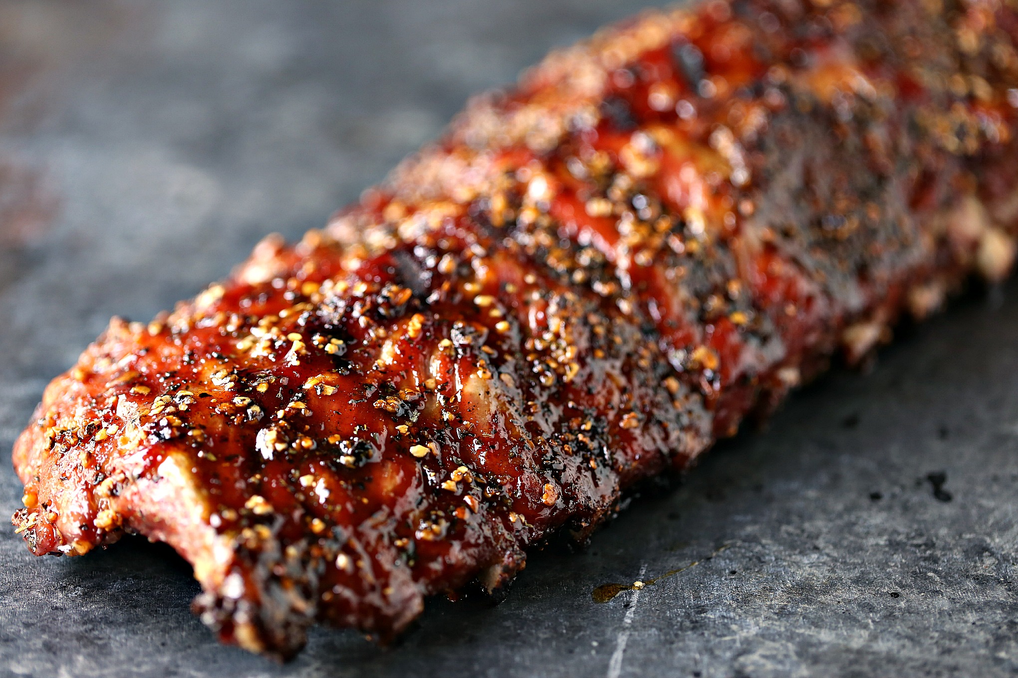 Easy Grilled Honey-Garlic Ribs from kissmysmoke.com- This is a simple, no-fuss recipe for honey garlic ribs that will make your taste buds do the happy dance. You can easily customize this to your own taste and heat preferences. Make this recipe today!