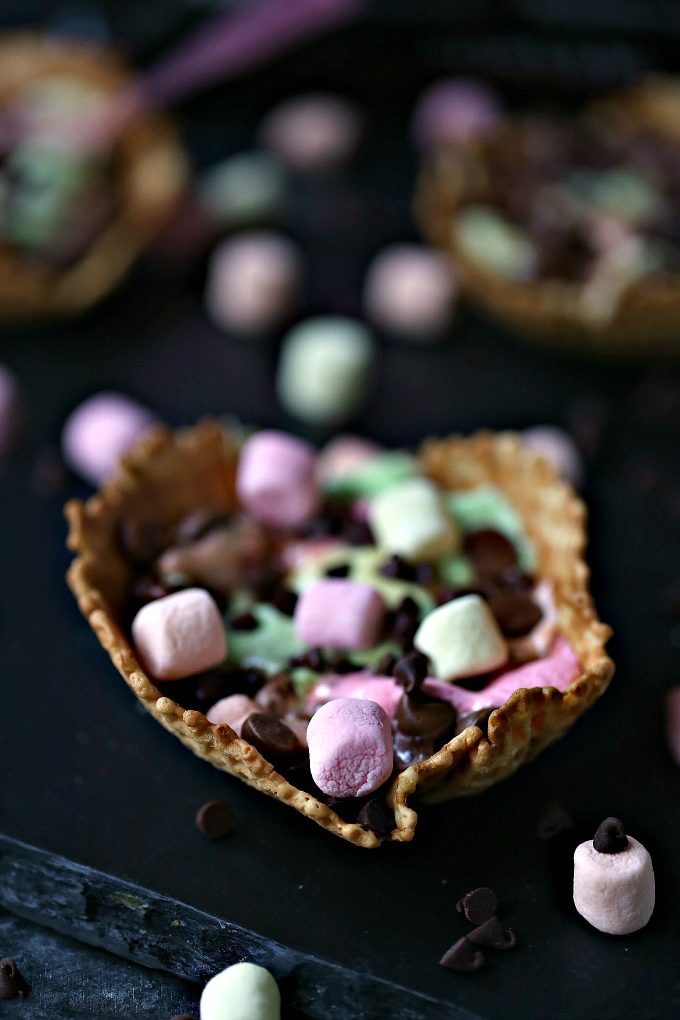 S'mores Campfire Waffle Cups layered with chocolate chips and multi-colored mini marshmallows in a waffle cup