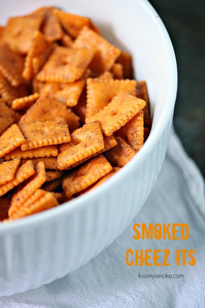 Smoked Cheez Its served in a white bowl. Perfect for tailgating, picnics or potlucks.